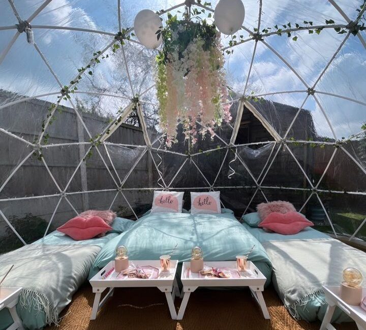 Pink floral sleepover setup inside igloo dome